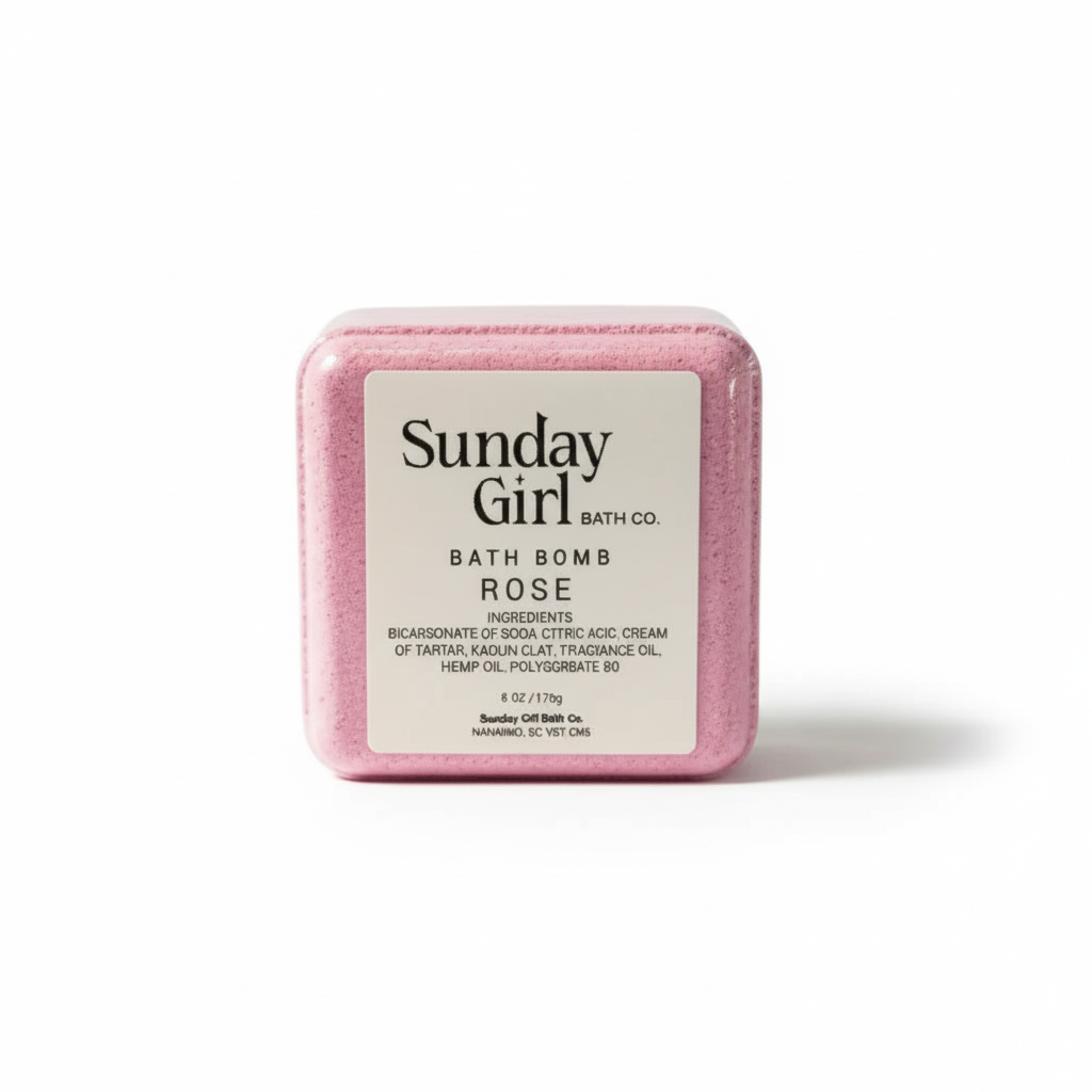 Pink bath bomb with 'Sunday Girl Bath Co.' label on a white background