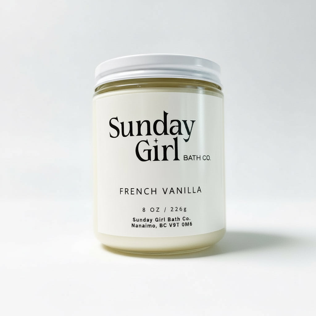 Candle jar labeled 'Sunday Girl Bath Co' with 'French Vanilla' on a light gray background