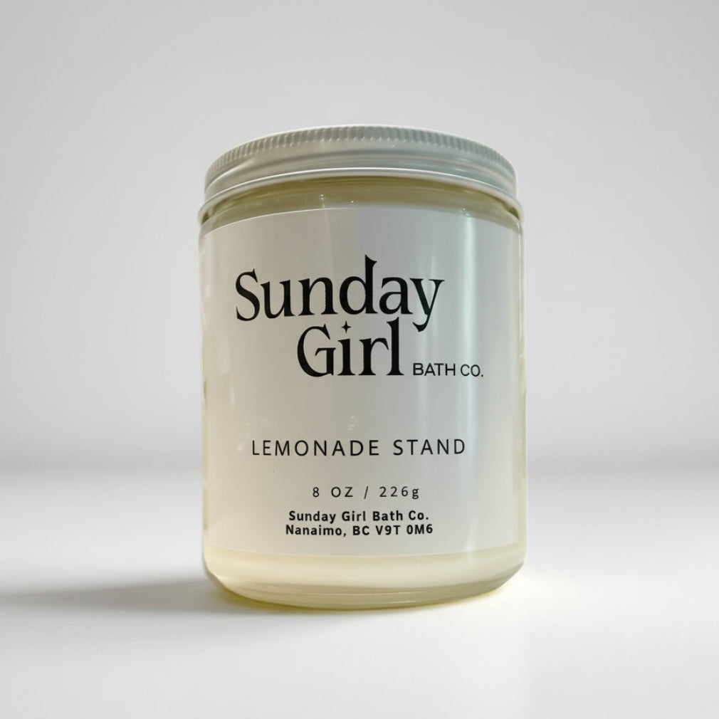 Jar of Sunday Girl Bath Co. candle on a light gray background