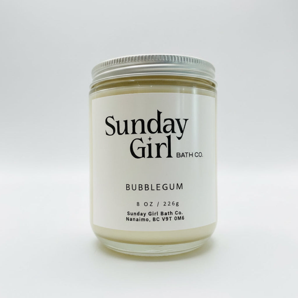 Candle jar labeled 'Sunday Girl Bath Co. Bubblegum' on a white background