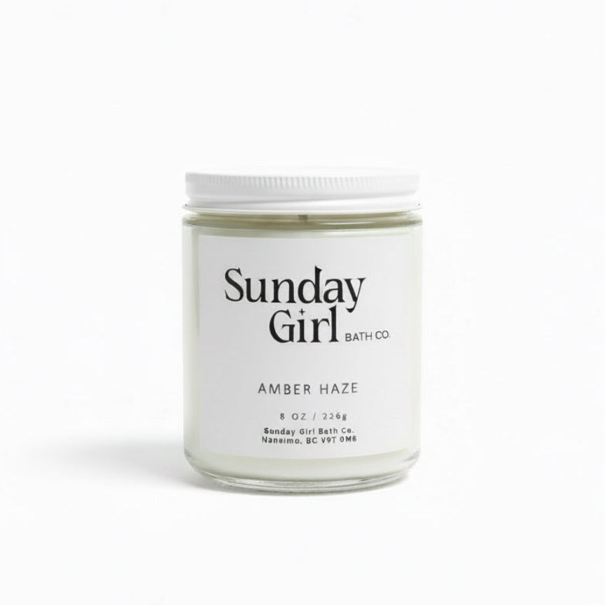Candle jar labeled 'Sunday Girl Bath Co' on a white background