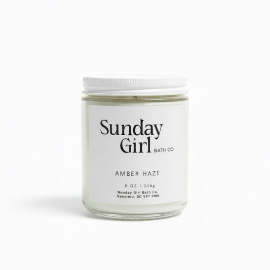 Candle jar labeled 'Sunday Girl Bath Co' on a white background