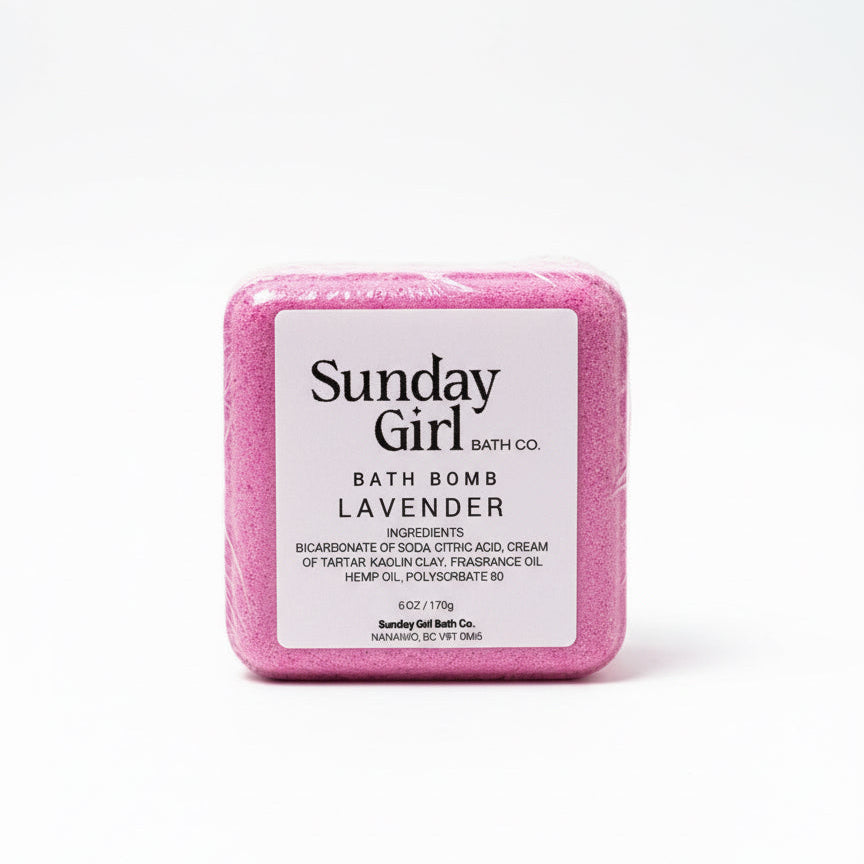 Pink bath bomb with 'Sunday Girl Bath Co' label on a white background