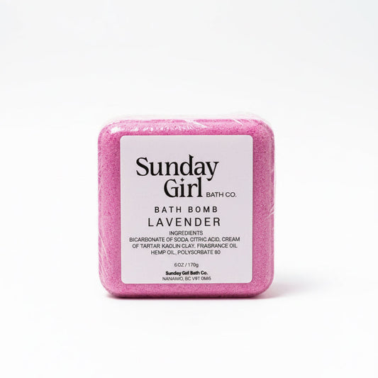 Pink bath bomb with 'Sunday Girl Bath Co' label on a white background