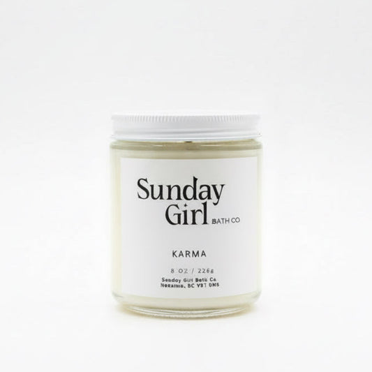 Candle jar labeled 'Sunday Girl' on a white background